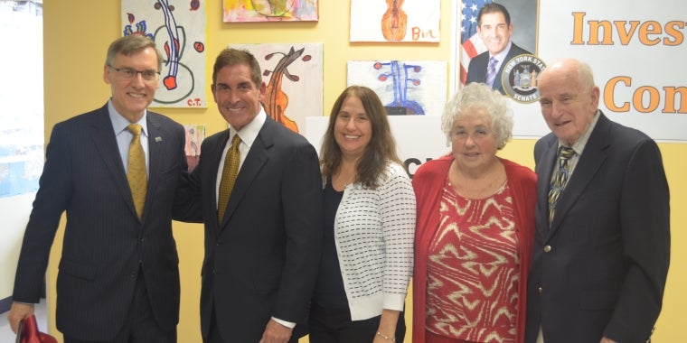 Gary Lind of AHRC joins Senator Klein and the family of the late Howie Stone as they unveil the new art center.