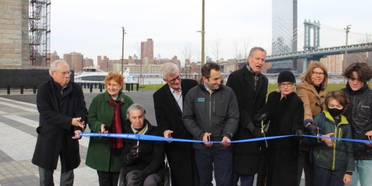 From left: Hank Gutman, Department of Transportation Commissioner; Assemblymember Jo Anne Simon; Victor Calise, Office for People with Disabilities Commissioner; State Senator Brian Kavanagh; Mayor Bill de Blasio; Deputy Mayor Vicki Been; Nancy Webster, Executive Director, Brooklyn Bridge Park Conservancy; and Emily Roebling's great-great-great grandsons, August and Chase Roebling. At the ribbon cutting ceremony for the Emily Warren Roebling Plaza in Brooklyn Bridge Park. Eagle photos by Delilah Johnson