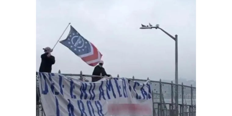 Members of Patriot Front unfurling a banner over the Belt Parkway this weekend
