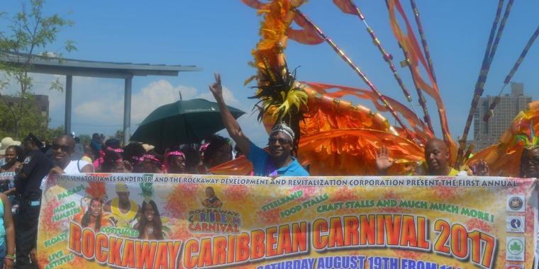 Senator Sanders lead the parade wearing a crown of black and yellow feathers.