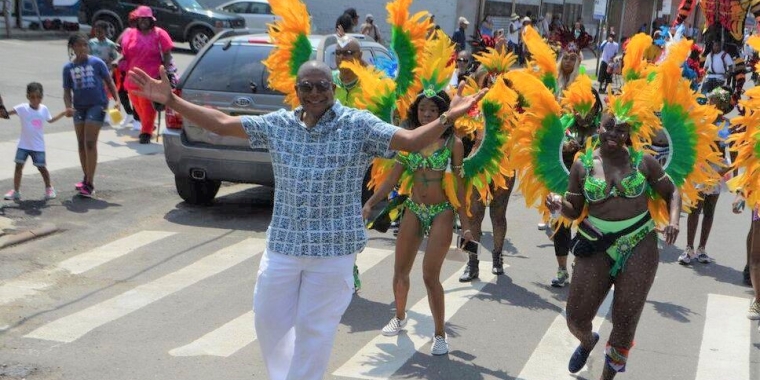 Senator Sanders marched with dozens of masqueraders in colorful costumes.