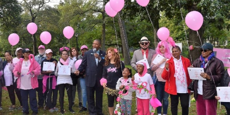Senator James Sanders Jr., center, joined Flowers of Hope for a Breast Cancer Awareness Walk in Brookville Park.