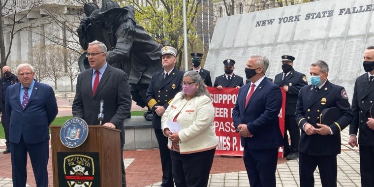 Senator Stec discusses legislation for volunteer firefighters at an Albany news conference in front of the Fallen Firefighters Memorial.