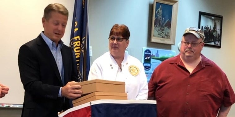 Senator Gallivan presents a NYS flag to the parents of Eagle Scout and U.S. Army Captain John Levulis of Eden.
