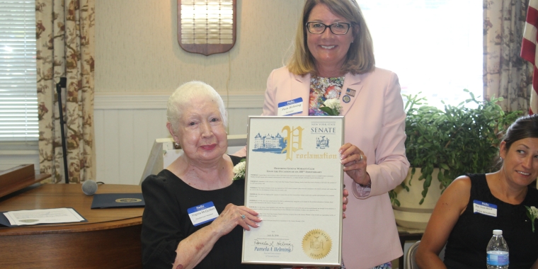Senator Pam Helming presents a New York State Senate Proclamation to Geneva Women’s Club President Virginia McQuilken to recognize the organization’s 100th anniversary during a luncheon celebration on Monday, July 16.