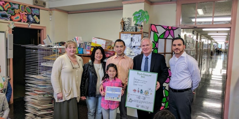 Elisia Zeng (front) is joined by her parents, Albert and Mei; her Principal, Dr. Janet Caraisco (left); and her teacher Mr. Carneiro (right) as she is presented her poster and certificate by Senator Tony Avella