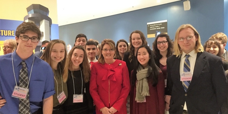 Senator Pam Helming stands with a group of students from Webster Schroeder High School in Albany following the annual State of the State address.