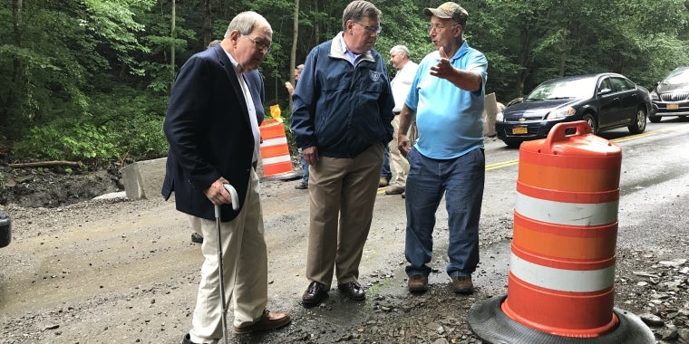 From left, Assemblyman Gary Finch, Senator James Seward, Sempronius Town Board Member David Becker assess flood damage during a tour of Cayuga County roads.