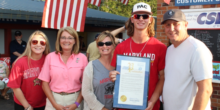 Senator Pam Helming stands with Ben Cowles, a recent Newark High School graduate who now plays for the Newark Pilots, and the Cowles family after presenting him with a New York State Senate Proclamation recognizing him for being named Finger Lakes East Player of the Year during last year's Senator Helming Night at Colburn Park.