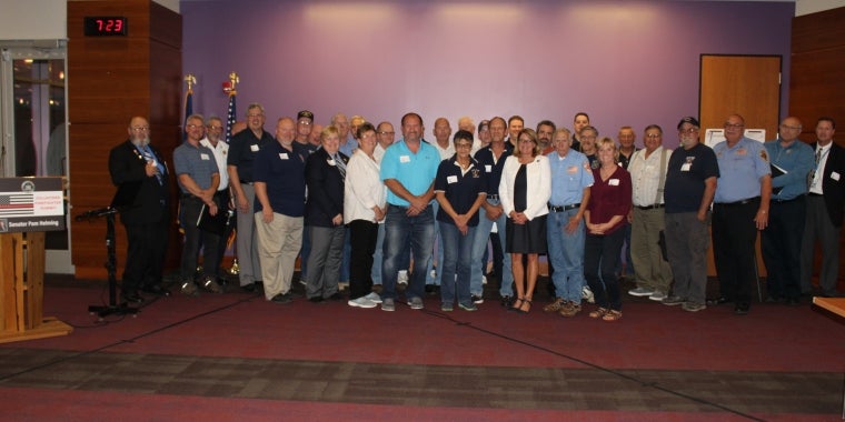 Senator Pam Helming stands with the more than 50 representatives of volunteer fire departments who attended her Volunteer Firefighter Summit at Finger Lakes Community College.