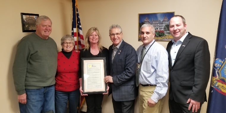 Senator Tedisco presenting Terri Brubaker with a NYS Senate Citation. Pictured L-R, Brubaker’s parents Barry and Nancy Hampton, Terri Brubaker, Senator Jim Tedisco, Fulton County Sheriff Richard Giardino, and Mayfield Mayor Jamie Ward