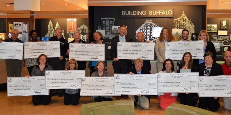 Senator Chris Jacobs is pictured with representatives from the twelve libraries across the 60th Senate District after presenting ceremonial checks marking a combined $120,000 in support for the Buffalo & Erie County Public Library System.