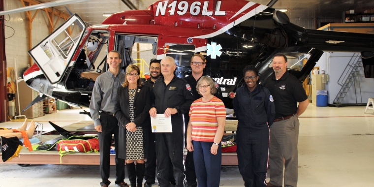 From left to right: Mercy Flight Central President and CEO Jeff Bartkoski, Senator Pam Helming, Flight Nurse Jason Camilo, Chief Pilot Ron Fast, Flight Paramedic Drew Cusimano, Shirley Fast, Ngao Molungwe, a ride-along program participant, and Director of Operations Jim Mizerak.