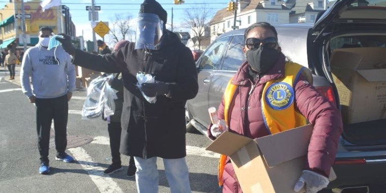 Senator Sanders, center, was joined by members of the Richmond Hill / South Ozone Park Lions Club and distributed PPE to passersby on foot and those driving by in their cars.