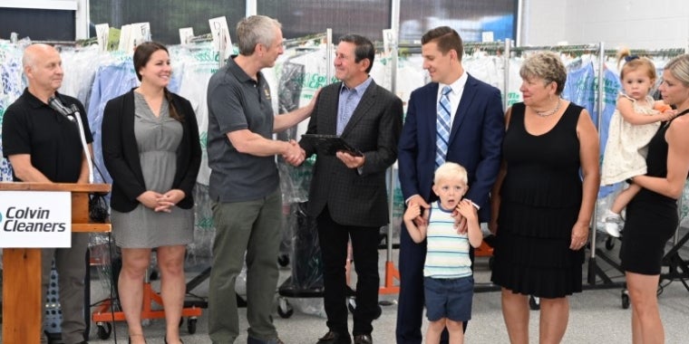 Village of Kenmore Mayor Patrick Mang (left) and Senator Sean Ryan present the Billoni family with a New York State Senate Empire Award, July 7, 2022