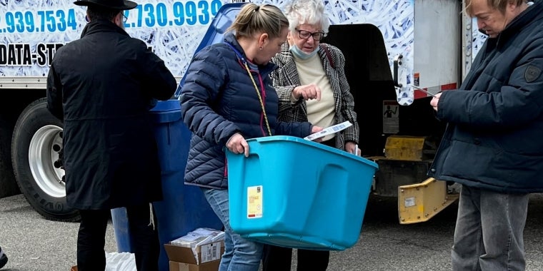 Senator Toby Ann Stavisky speaks with residents at a paper-shredding event in College Point