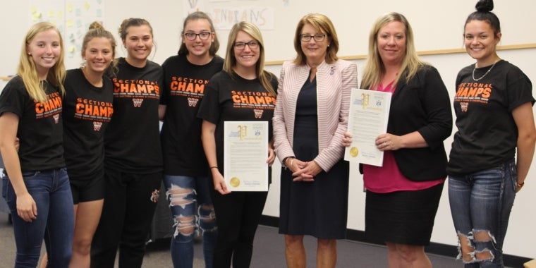 Senator Pam Helming with the Waterloo Indians varsity softball team that won the Section V, Class B2 championship during the spring season. From left: Emma Smithers, Kylie Tavano, Kennedy Beniamino, Brynn Rogers, Head Coach Kierstyn DeCory, Senator Helming, Athletic Director Christal Kent, and Bryce Fegley.