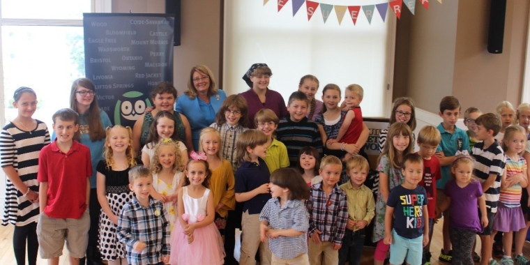 Senator Pamela A. Helming stands with children who completed Pioneer Library System’s summer reading program.