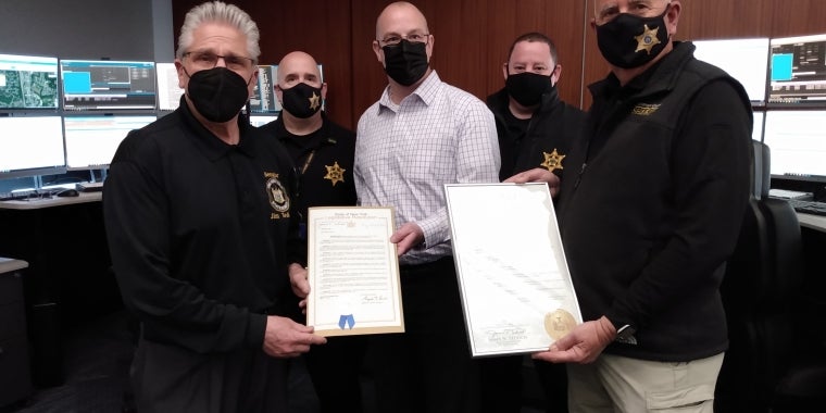 Pictured is Senator Tedisco presenting a New York State Proclamation and Resolution he sponsored to Saratoga County Sheriff Michael Zurlo and members of the Saratoga County Sheriff's 911 Dispatch Center.