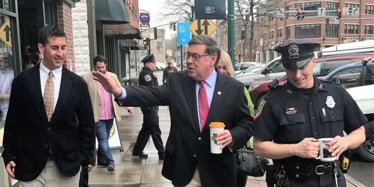 Sentator James L. Seward walks along Main Street Cortland to review several new downtown renovations and planned development projects. From left, Cortland Downtown Partnership Executive Director Adam Megivern, Senator Seward, Cortland Community Police Officer Jesse Abbott.