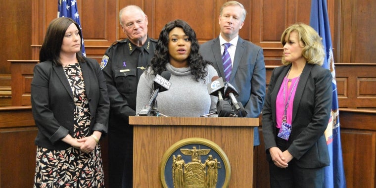 At a press conference where Senator Chris Jacobs marked Domestic Violence Awareness Month by announcing funding for key service providers, Clarissa, a survivor of abuse, shares her inspiring story.  Listening to Clarissa from l-r are Crisis Services CEO Jessica Pirro, Erie County Sheriff Timothy B. Howard, Senator Jacobs, and Family Justice Center Executive Director Mary Murphy.
