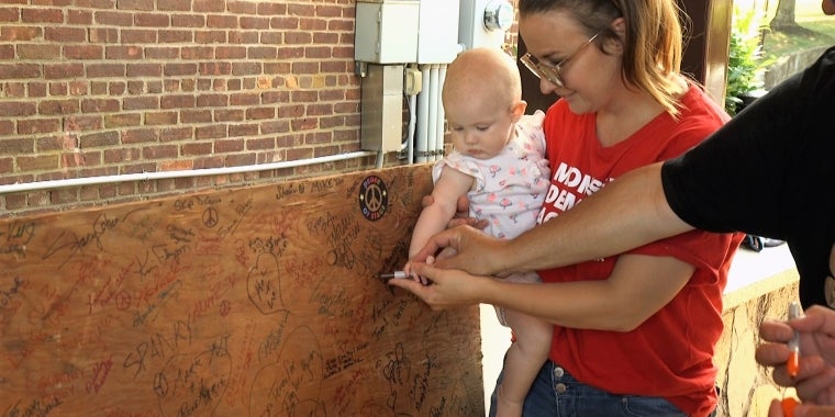 Residents of all ages sign the Woodstock Stage Panel in support for common-sense gun laws