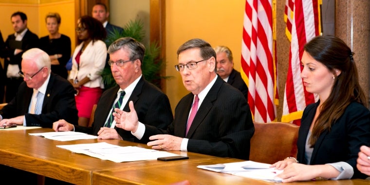Senator James L. Seward (second from right) leads debate during the Senate Insurance Committee meeting on his first day back at work following successful bladder cancer surgery in April. Seated from left, Senator Martin Golden, Senator Neil Breslin, Senator James Seward, Natalie Bernardi Senate Insurance Committee Counsel/Director.