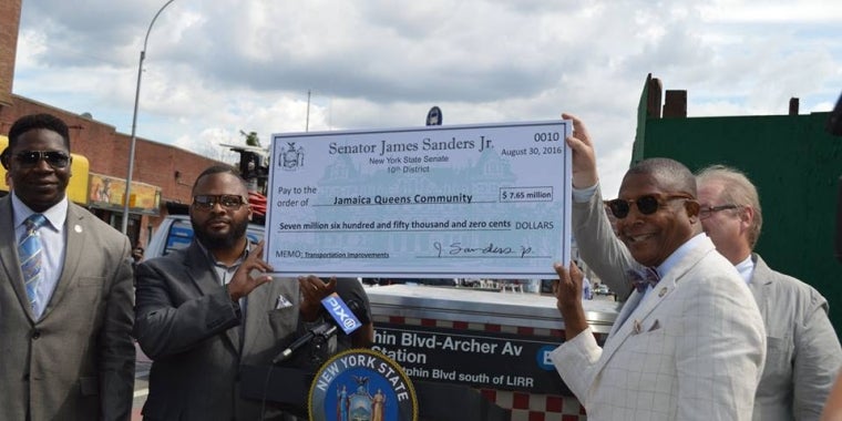 Senator Sanders presents a check representing the funding coming from the state for transportation improvements to Jamaica.