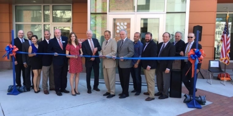 Senator Bonacic joins officials in cutting the ribbon at Wooster Hall.