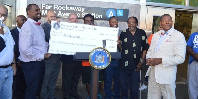 Senator Sanders displays a check representing the funding coming from the state.