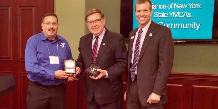Senator James L. Seward center) receives the 2016 Y Champion award from Oneonta YMCA Executive Director Frank Russo (left) and Alliance of NYS YMCAs Executive Director Kyle Stewart (right).