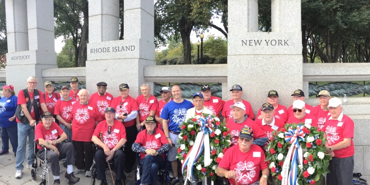 Senator Ortt stands with veterans in front of the WWII Memorial in Washington as part of the WNY Warriors Flight